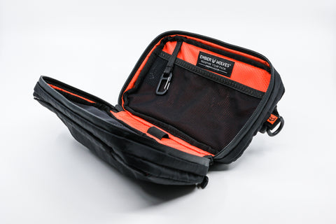An Alpha Pack open showing its interior at a three quarter angle | Color: Black VX | Size: 1.8L