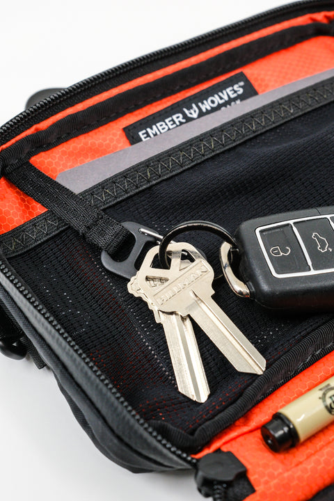 Alpha Pack interior close up showing carabiner with keys and label | Color: Black VX | Size: 1.8L
