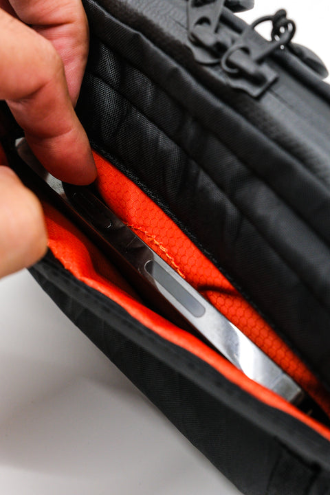 Alpha Pack interior close up showing phone pocket with phone attached | Color: Black VX | Size: 1.8L