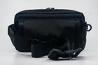An Alpha Pack shown from the back with strap and Fidlock buckle | Color: Black VX | Size: 2.6L