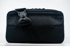 An Alpha Pack shown from the front with strap with Fidlock buckle draping over the front | Color: Black VX | Size: 2.6L