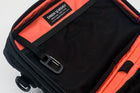 An Alpha Pack shown open and cropped so you can only see the top portion and built in carabiner and label | Color: Black VX | Size: 2.6L