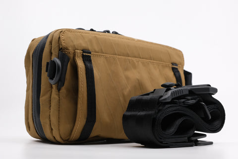 An Alpha Pack shown from the back three quarters with strap  | Color: Brown VX | Size: 1.8L