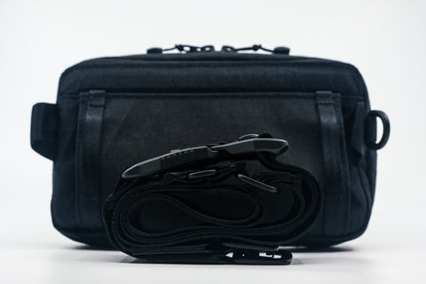 An Alpha Pack from behind with strap and buckle rolled up.  | Color: Tactical Black | Size: 1.8L