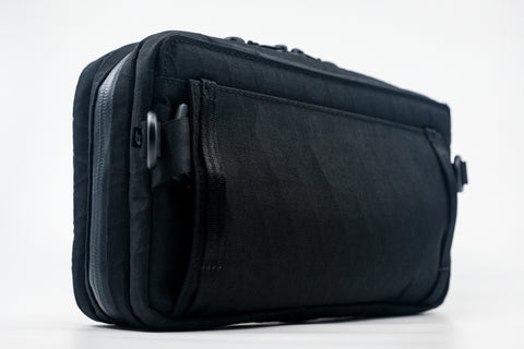 An Alpha Pack shown from the back at three-quarters angle. | Color: Tactical Black | Size: 2.6L