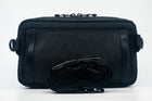 An Alpha Pack with rolled black strap in front. | Color: Tactical Black | Size: 2.6L