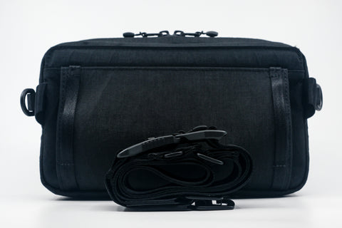 An Alpha Pack with rolled black strap in front. | Color: Tactical Black | Size: 2.6L